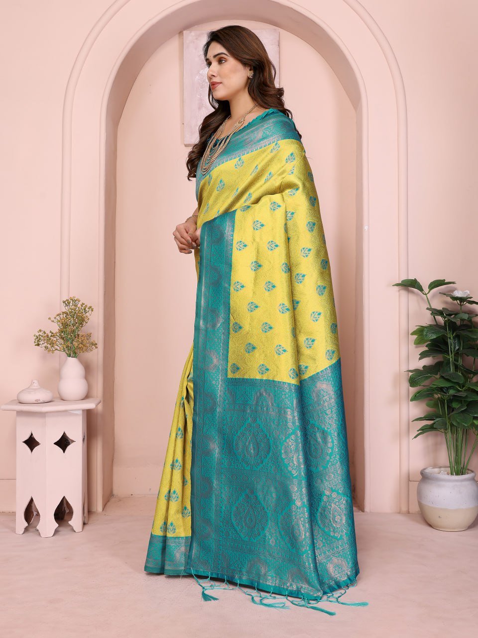 Folded yellow and turquoise Banarasi soft silk saree with golden jacquard border – premium ethnic wear