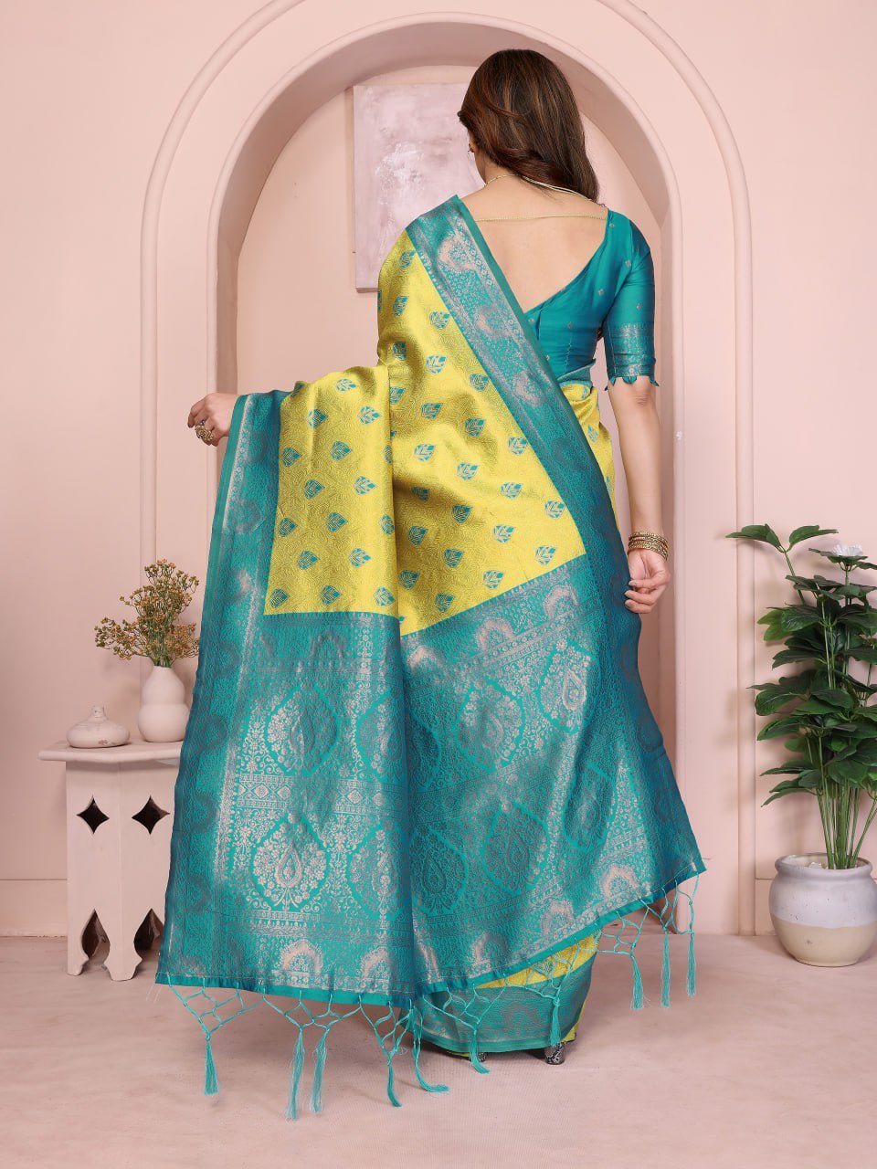 Pallu view of yellow and turquoise Banarasi silk saree featuring golden zari jacquard detailing