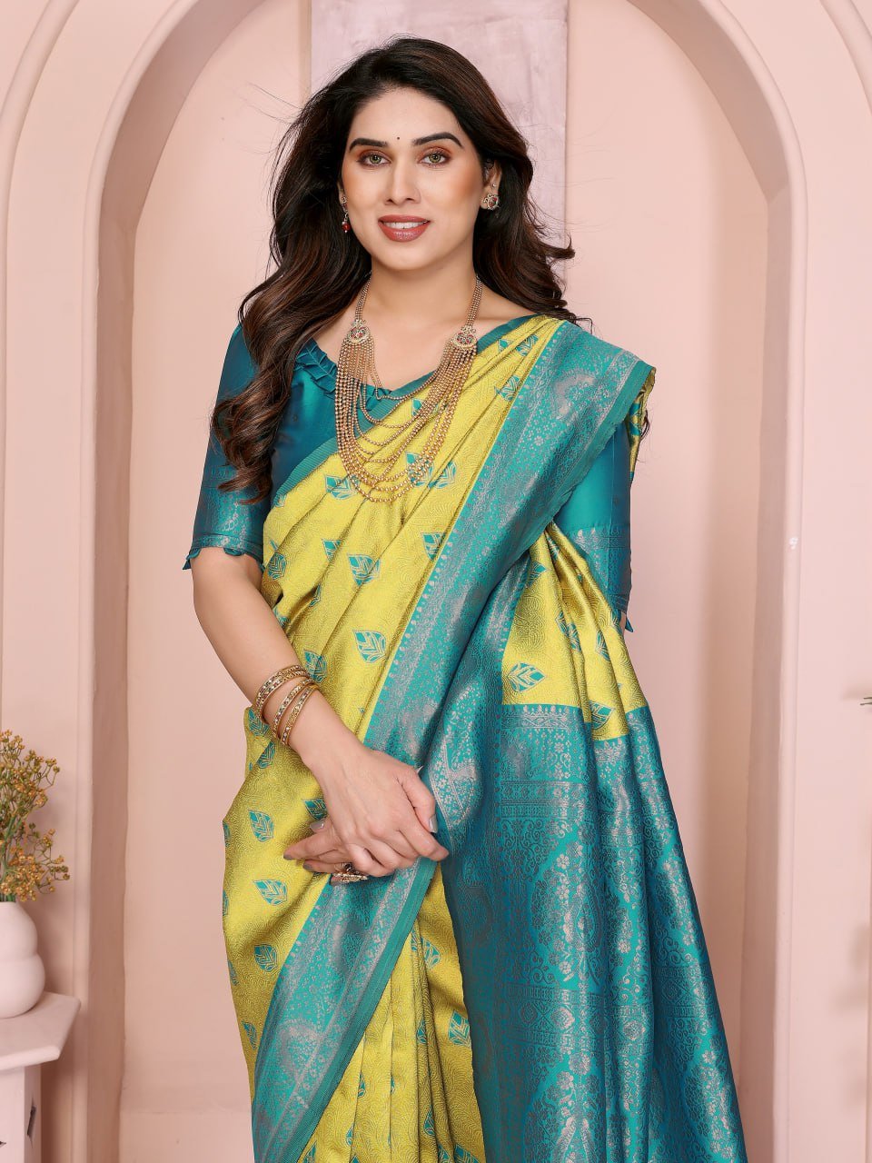 Close-up of yellow and turquoise Banarasi soft silk saree with intricate jacquard zari border design