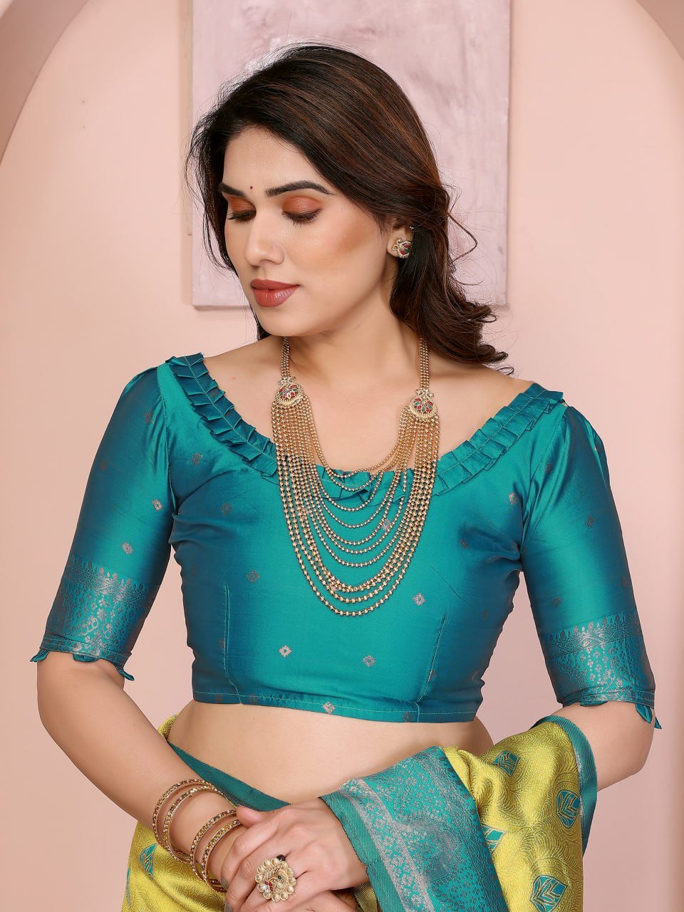 Folded yellow and turquoise Banarasi soft silk saree with golden jacquard border – premium ethnic wear