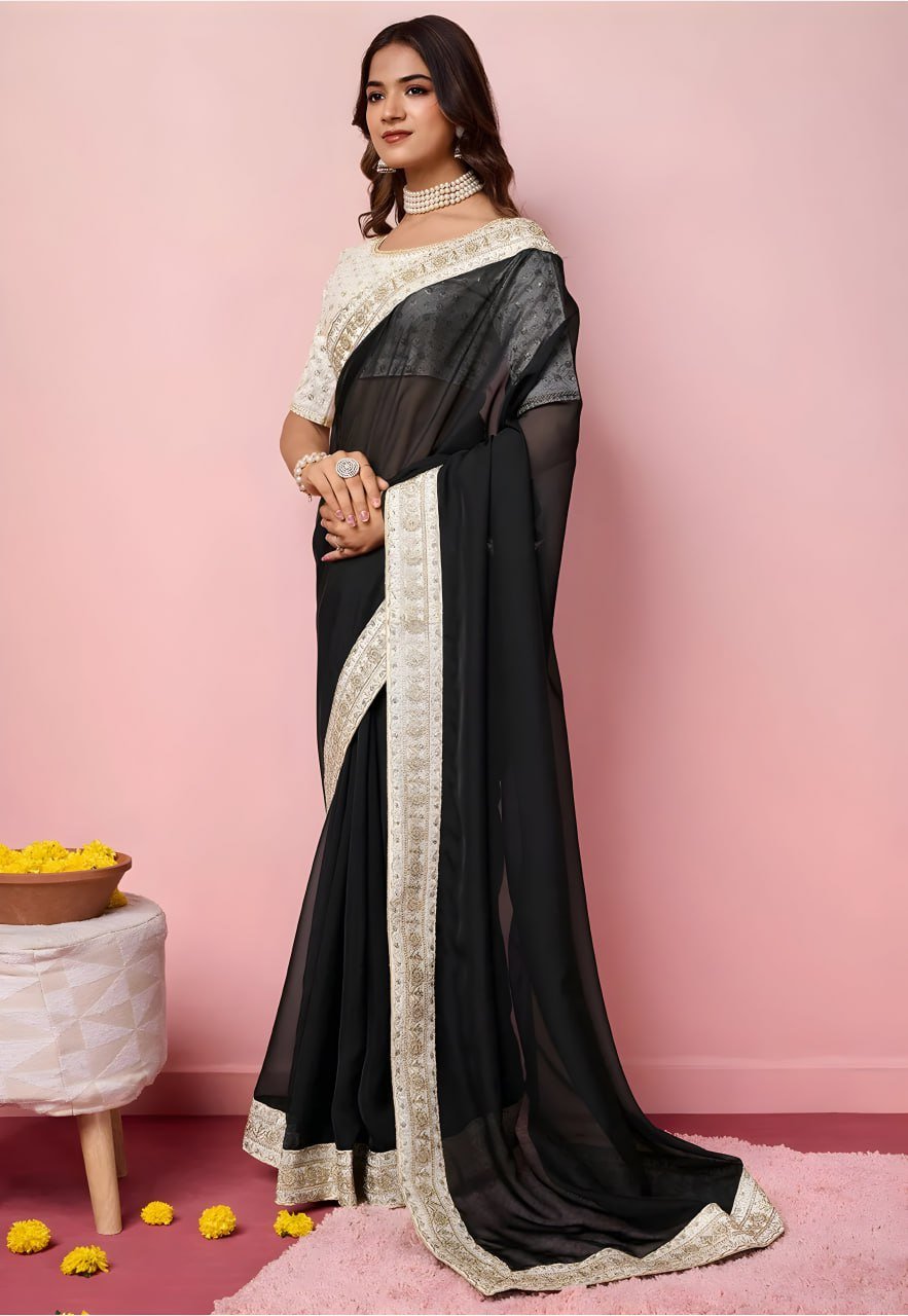 Close-up of black organza saree fabric with intricate embroidery and zari detailing