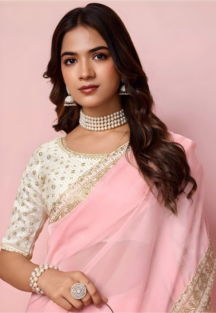 Woman wearing pink organza saree with heavy embroidered mono banglori blouse – wedding party wear saree