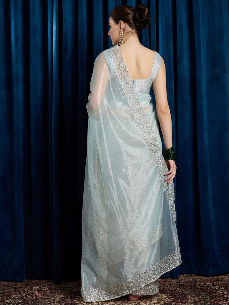 Matching blouse piece of sky blue cutwork net saree with beads and sequins