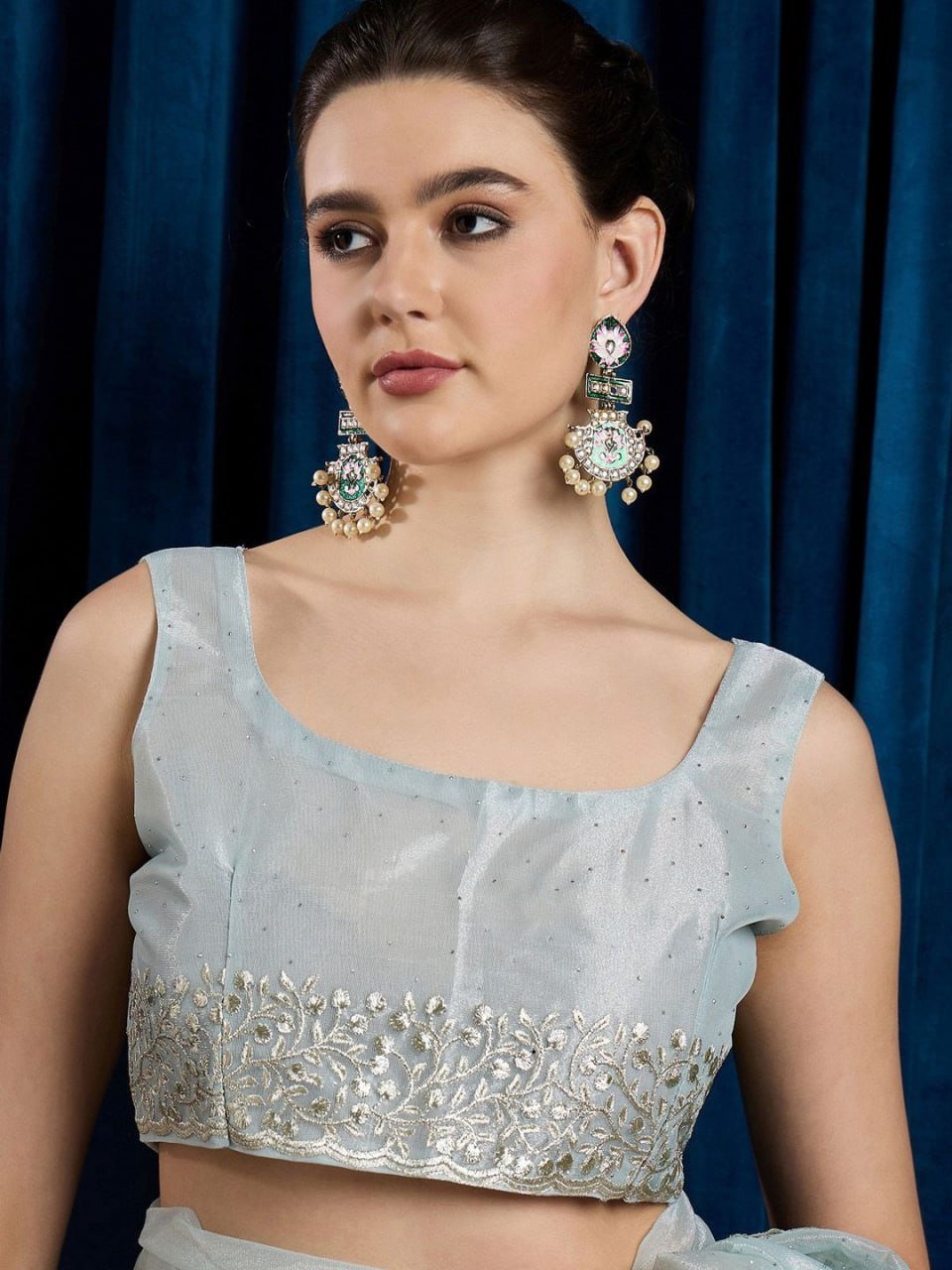 Matching blouse piece of sky blue cutwork net saree with beads and sequins