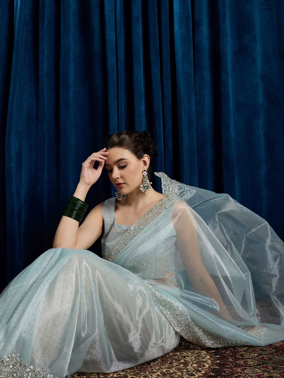 Woman wearing sky blue net saree with cutwork, beads, and stone embroidery – party wear saree 2025