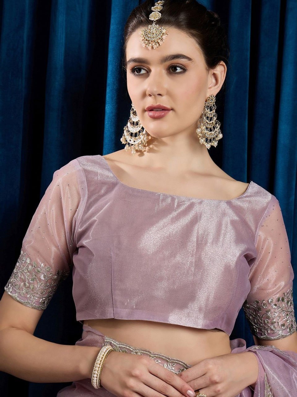 Matching embellished blouse piece of pink hotfix cutwork net saree with beads and stones