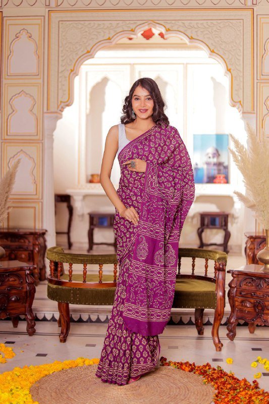 Folded dark purple cotton saree with bold printed motifs – lightweight stitched saree