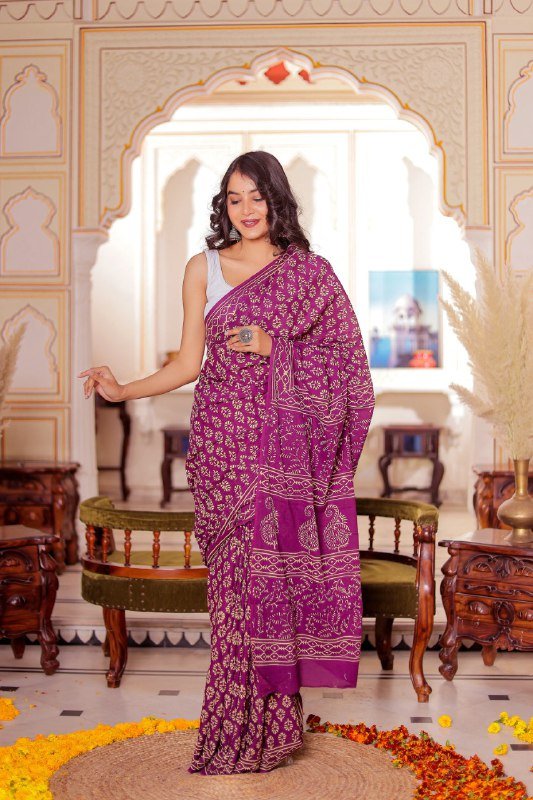 Folded dark purple cotton saree with bold printed motifs – lightweight stitched saree