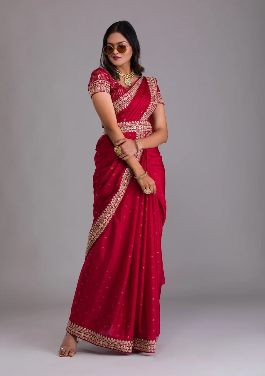 Woman wearing red heavy work designer saree with sequins and belt – elegant bridal saree for wedding