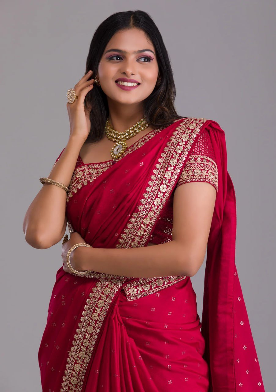 Close-up of red saree fabric with sequins embroidery and zari detailing – designer heavy work saree