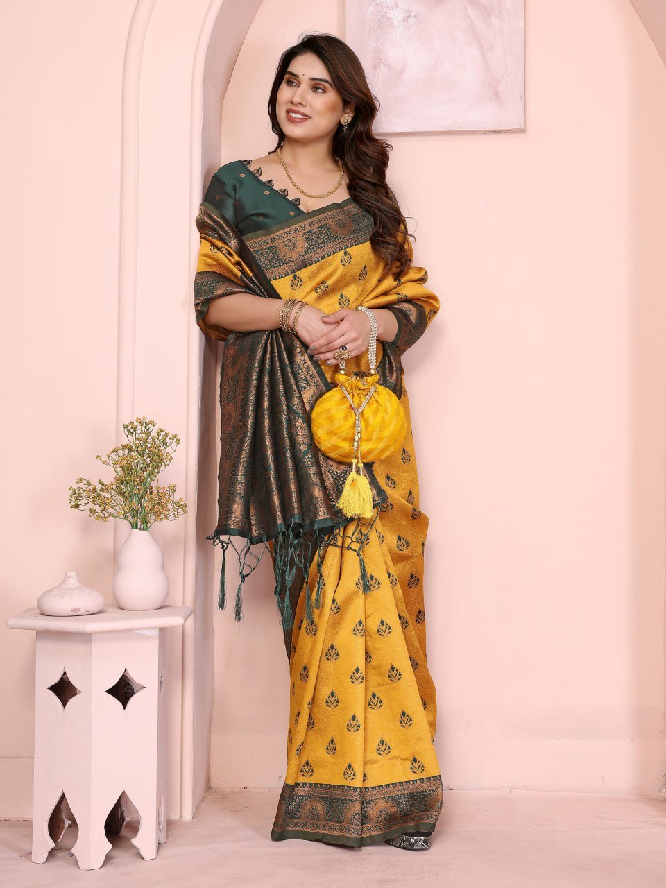 Elegant yellow silk saree draped on model with jacquard border, festive wedding wear