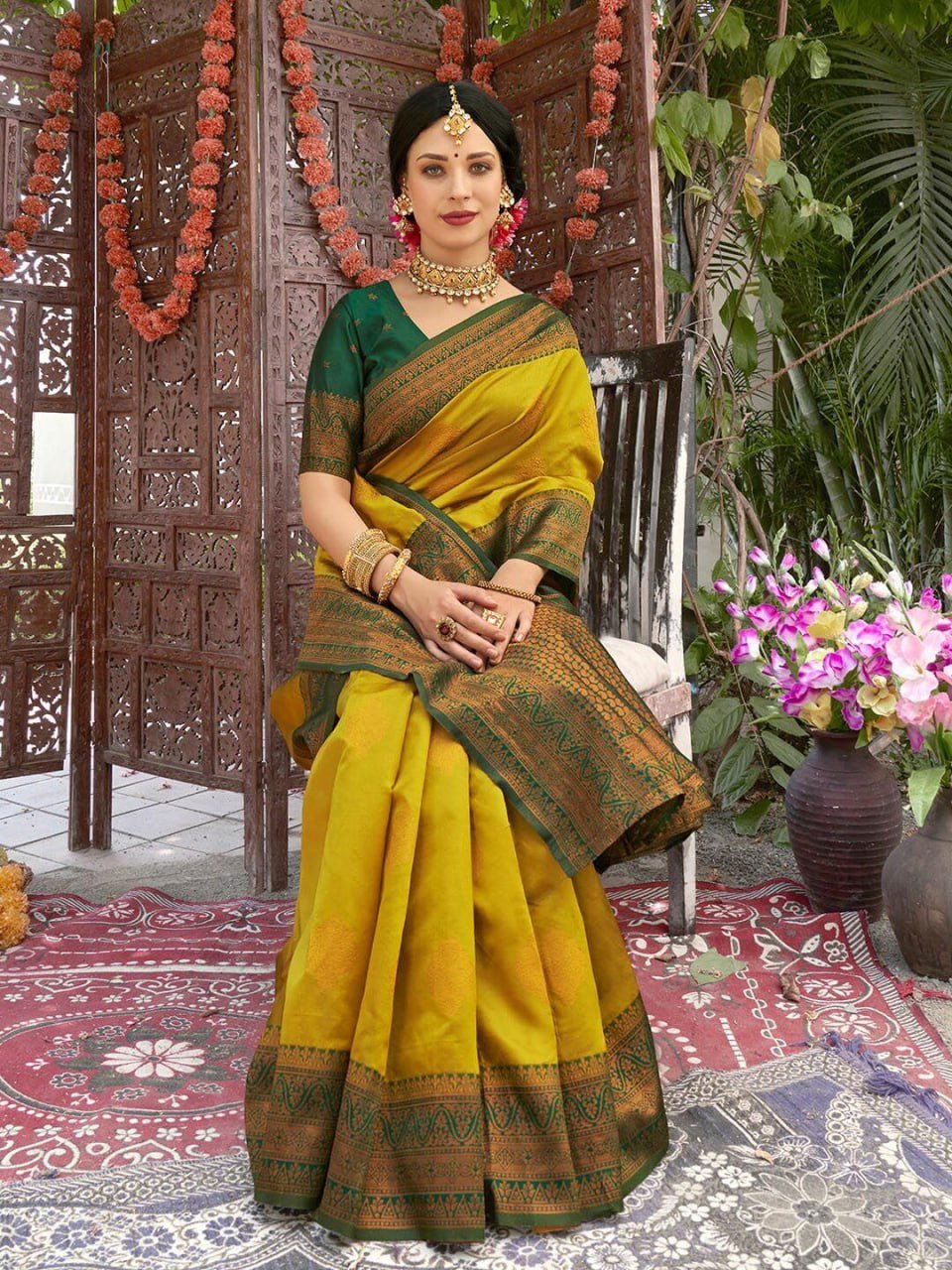 Yellow Banarasi soft silk saree pallu with intricate green border and gold zari motif detail