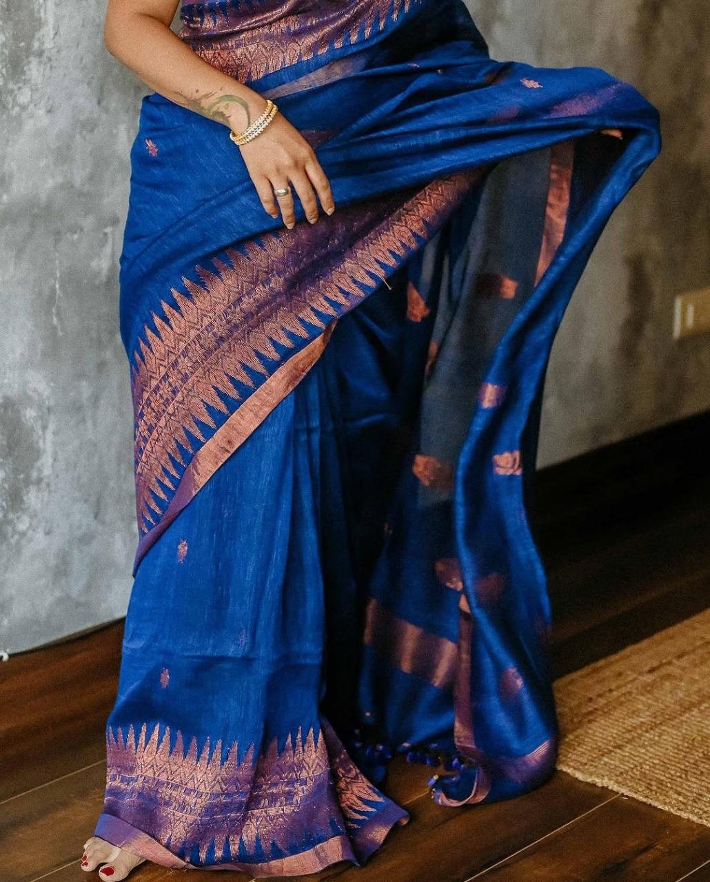 Close-up of jacquard weaving on navy blue lichi silk saree with rich detailing