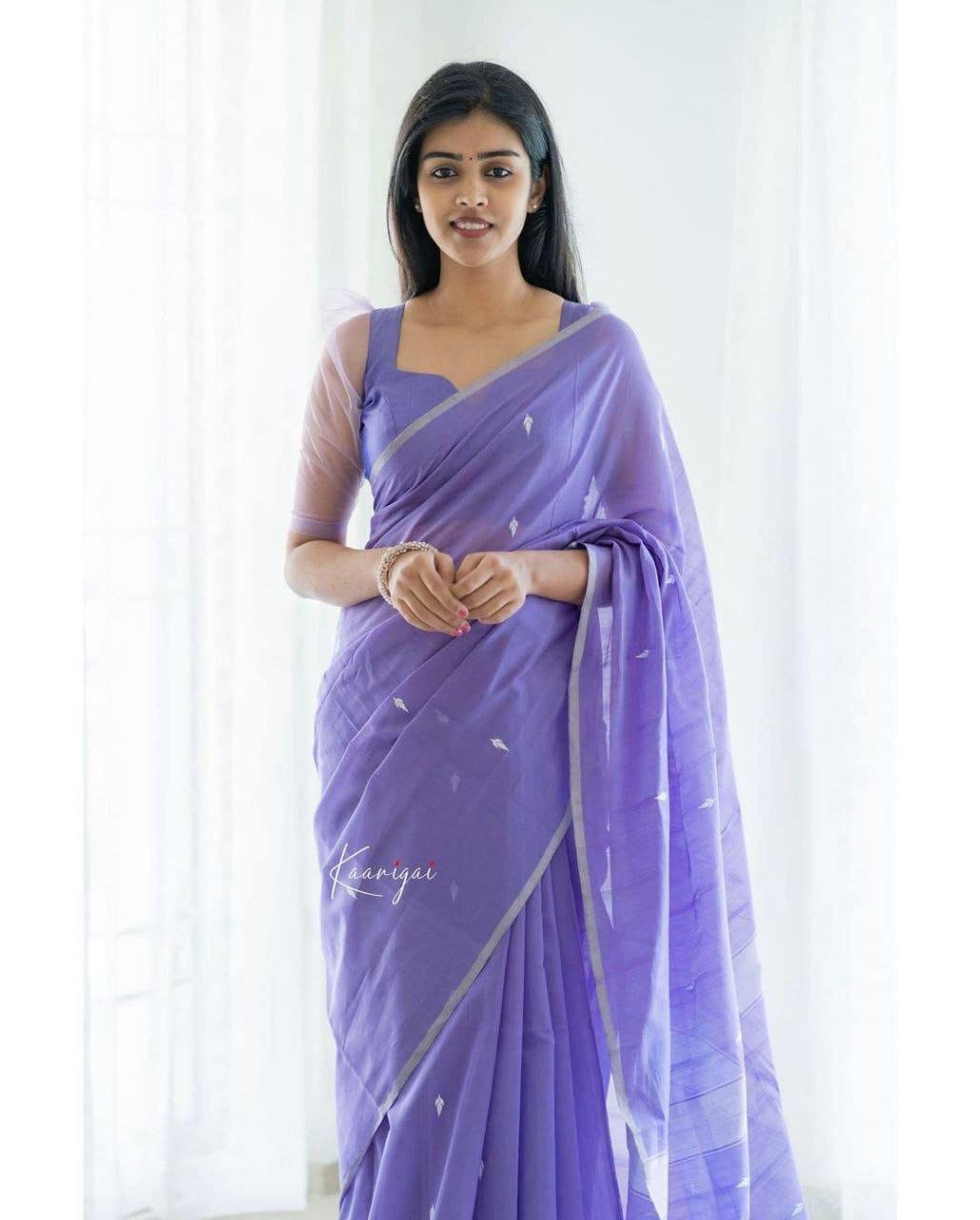 Woman wearing light purple jacquard work soft lichi silk saree – festive party wear saree