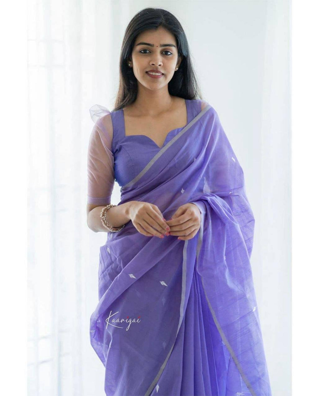 Close-up of light purple lichi silk saree fabric with jacquard weaving – soft silk designer saree