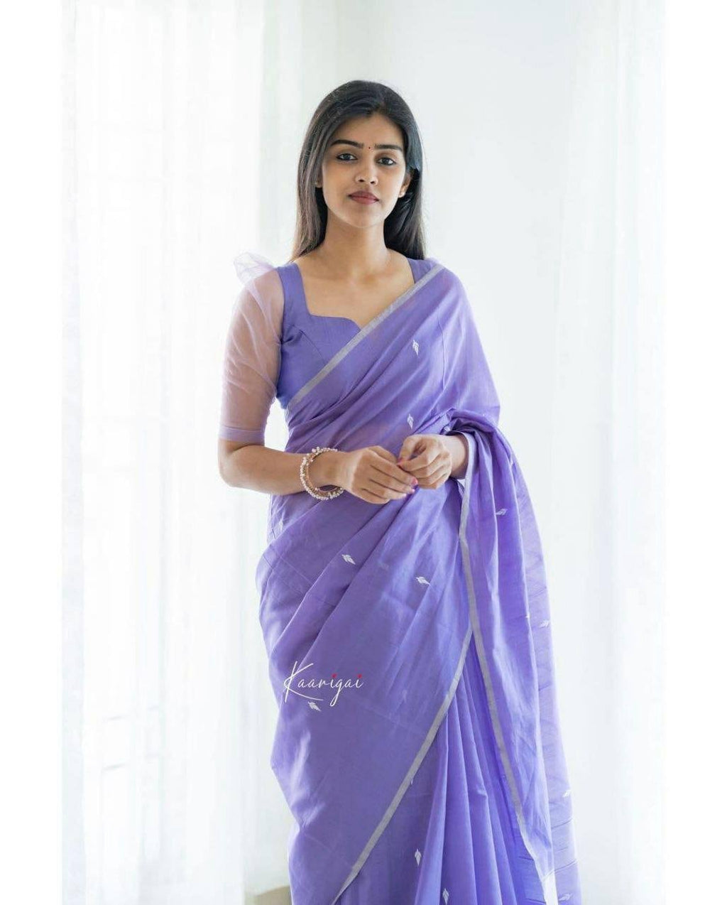 Woman wearing light purple jacquard work soft lichi silk saree – festive party wear saree