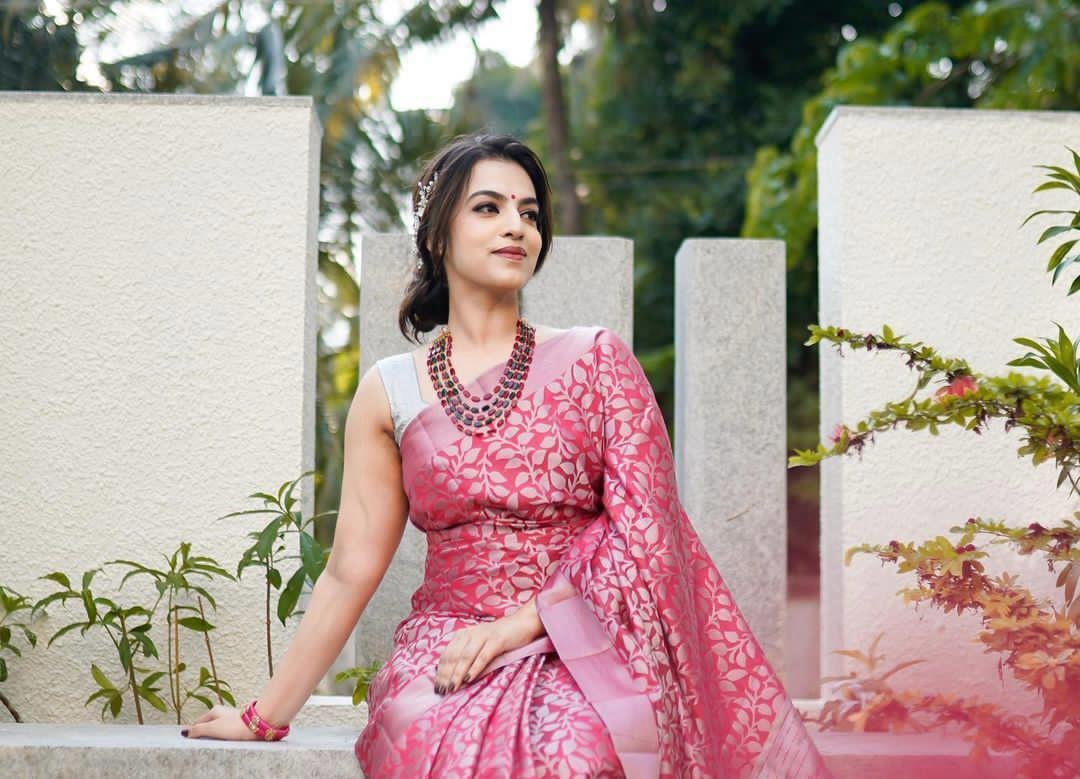 Woman wearing pink and white soft lichi silk saree with jacquard work
