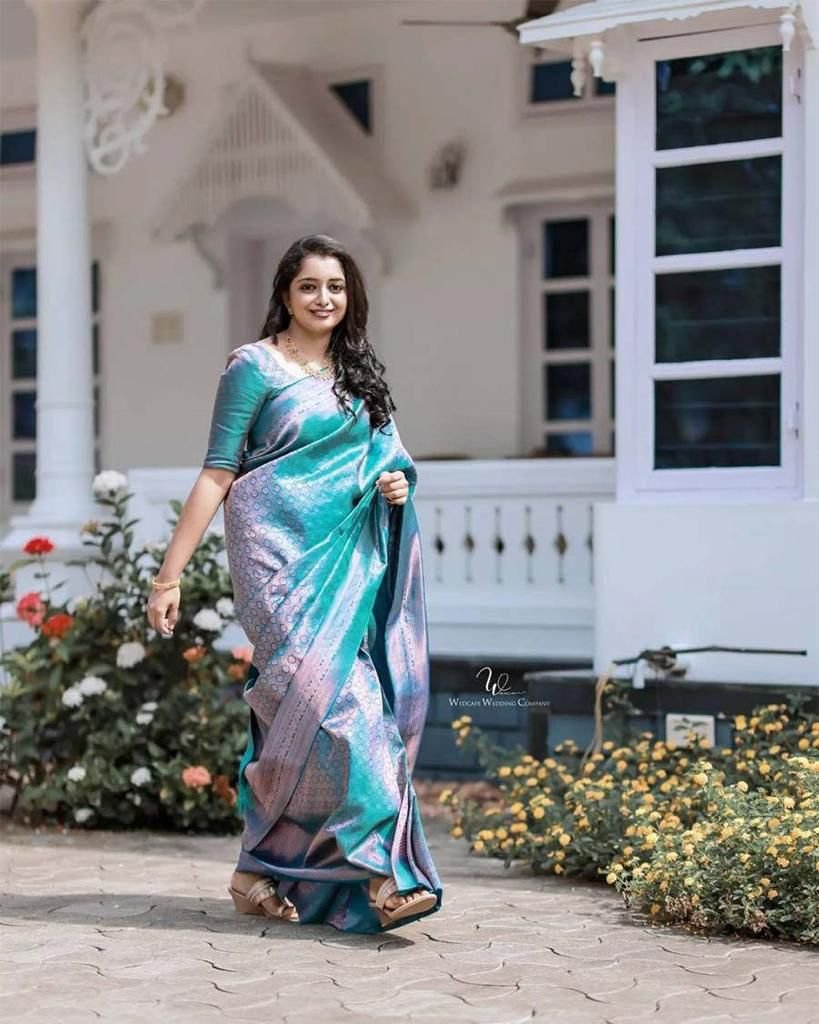 Woman wearing sky blue soft lichi silk saree with intricate jacquard motifs – wedding saree