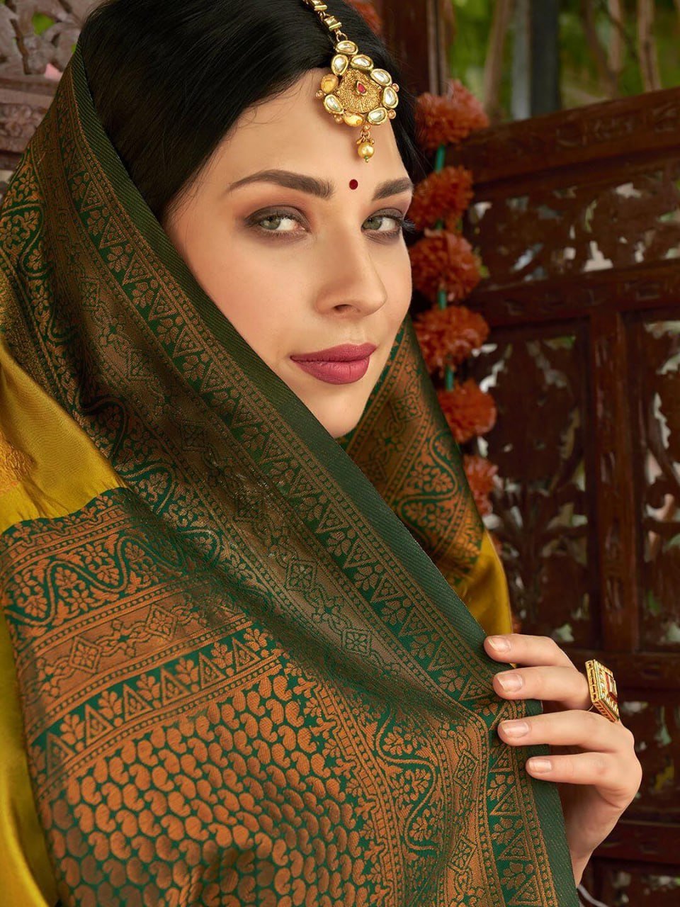 Indian woman wearing traditional yellow Banarasi soft silk saree, festive occasion styling